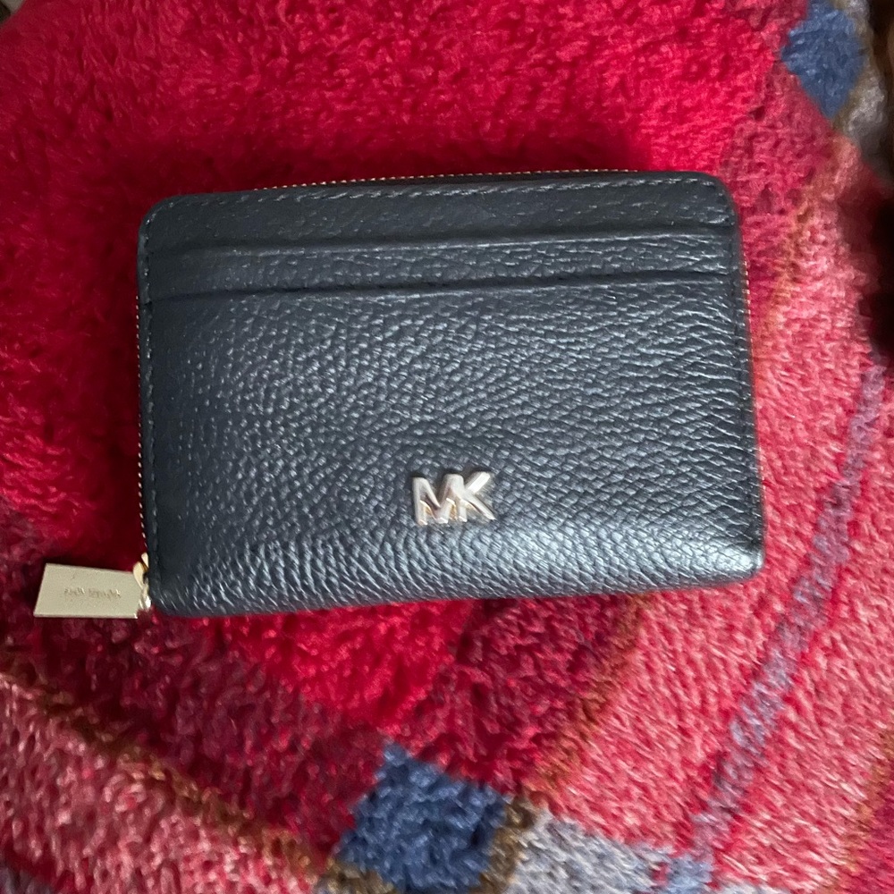 Michael kors black compact wallet in good condition lightly used .